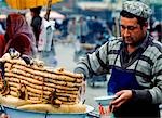Man serving sausages and sheeps lungs,Kashgar Sunday market,Xinjiang,China