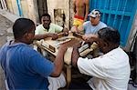 Men playing dominoes on table in street,Havana,Cuba