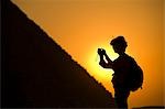 Woman photographing Pyramids at dusk,Giza,Cairo,Egypt