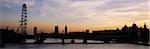 Looking up the Thames from Waterloo Bridge towards Hungerford Bridge,The London Eye and the Houses of Parliament at dusk,London,UK.