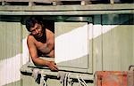 man looking out of local fishing boat,malaysia