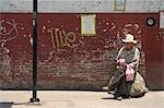 Maxican man sitting along wall,Oaxaca,Oaxaca State,Mexico