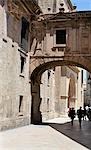 People under archway of cathedral,Valencia,Spain