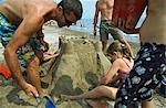 Family making sandcastles,sandy beach,Weymouth,Dorset,England,UK