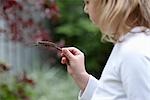 Girl Holding a Caterpillar on a Stick