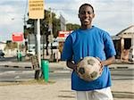 Teenage african boy with football