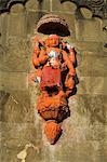 Hindu temple god on wall on banks of the Narmada River, Maheshwar, Madhya Pradesh state, India, Asia
