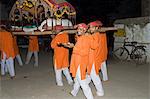 Men carrying a palaquin with the portrait of one of India's most celebrated 18th century female rulers, Ahilya Bai Holkar, during a Hindu ceremony, Maheshwar, Madhya Pradesh state, India, Asia