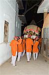 Men carrying a palaquin with the portrait of one of India's most celebrated 18th century female rulers, Ahilya Bai Holkar, during a Hindu ceremony, Maheshwar, Madhya Pradesh state, India, Asia