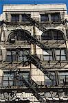 Fire escapes on the outside of buildings in Spring Street, Soho, Manhattan, New York City, New York, United States of America, North America