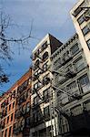 Fire escapes on the outside of buildings in Spring Street, Soho, Manhattan, New York City, New York, United States of America, North America