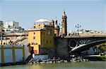 Puente de Isabel II, also known as Puente de Triana, with Triana district on left and the river Rio Guadalquivir, Seville, Andalusia, Spain, Europe