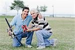 Father and Son Playing With Remote Control Airplane