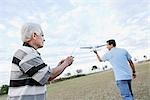 Father and Son Playing With Remote Control Airplane