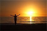 Femme sur la plage au coucher du soleil, la Floride, Etats-Unis