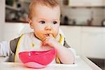 Baby in High Chair Eating
