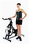 Woman Standing by Stationary Bicycle