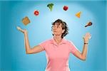 Woman juggling different foods
