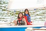 Two girls sailing small boat