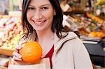 Woman holding small pumpkin