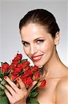Female beauty model smelling roses
