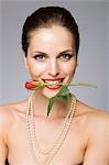 Female beauty model rose in mouth