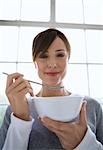 Woman holding spoon and bowl.