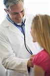 Male Doctor examining girl patient