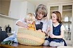 grandmother and grandchildren packing