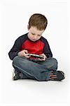 Boy Playing Handheld Video Game