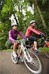 Women Riding Bikes in Forest, Seattle, Washington, USA