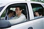 Man driving family on road trip