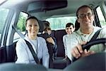 Family together in car on road trip