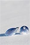 Christmas ornaments on snow-covered ground