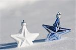 Star Christmas ornaments in snow