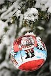 Ornement de Noël coloré accroché à neige givré branch