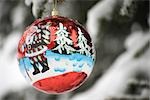 Colorful Christmas ornament hanging from branch