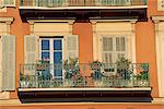 Detail of geraniums on a wrought iron balcony on an ochre coloured house in the Old Town of Nice, Alpes Maritimes, Cote d'Azur, French Riviera, Provence, France, Europe