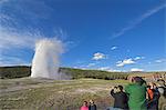 Crowds of spectators watching Old Faithful geyser erupting, Upper Geyser Basin, Yellowstone National Park, UNESCO World Heritage Site, Wyoming, United States of America, North America