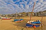 Strange cloud formation in the early morning with small Cornish fishing boats at low tide in the harbour at St. Ives, Cornwall, England, United Kingdom, Europe