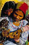 Two young women applying henna to the hand, Pushkar, Rajasthan state, India, Asia