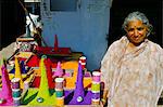 Hindu woman selling colourful powders, Pushkar, Rajasthan state, India, Asia