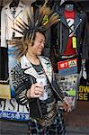 Boy with spiky hair and tartan kilt,drinking beer,Tokyo,Japan,Asia