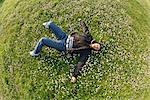 Girl lying down on flowers and grass