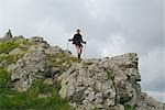 Woman backpacking along with hiking sticks