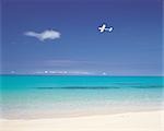 A Plane Flying Near The Coastline