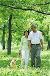 Older Couple Walking with Dog