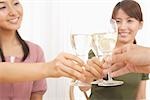Close-up hands of women enjoying champagne