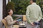 Rear view of a man holding gift while woman looking at him