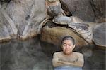 Front view of a man relaxing in natural hot spring